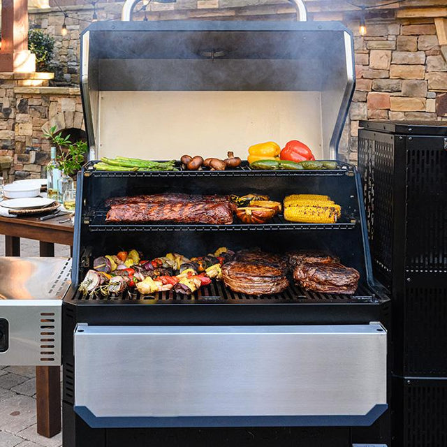 Masterbuilt gravity fed charcoal barbecue. Image shows a range a barbecue food cooking