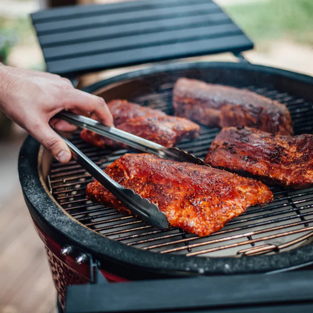 Kamado Joe and Big Green Egg ceramic charcoal grills displayed side by side, showcasing their premium build, versatile cooking capabilities, and signature red and green designs. Available exclusively at Hot Things in Perth with free assembly and delivery.