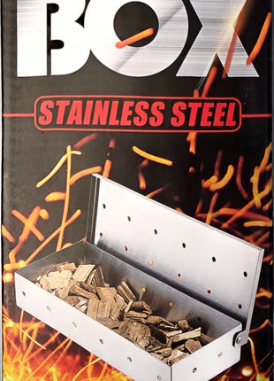 A heavy-duty stainless steel smoker box shown on its retail packaging. The packaging features bold white and red text reading 'SMOKER BOX' and 'STAINLESS STEEL' against a black background with fiery embers and wood chips inside the open smoker box.